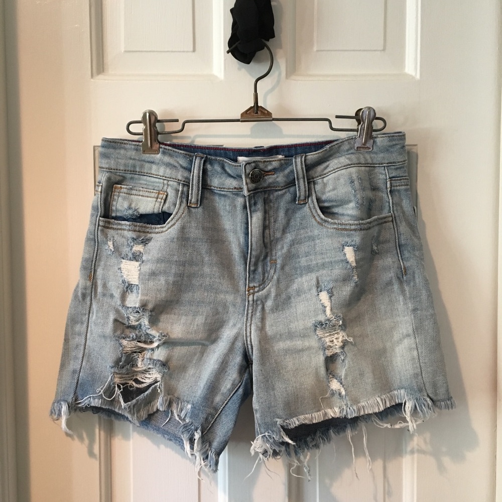 Low rise distressed and ripped denim shorts